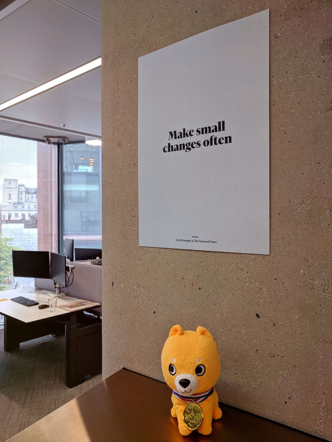 A poster on the wall with the text "Make small changes often"